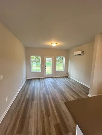 wooden floor in an empty room with a window