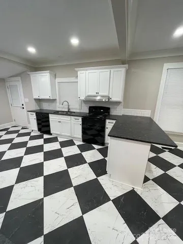 a kitchen with a black white checkered floor