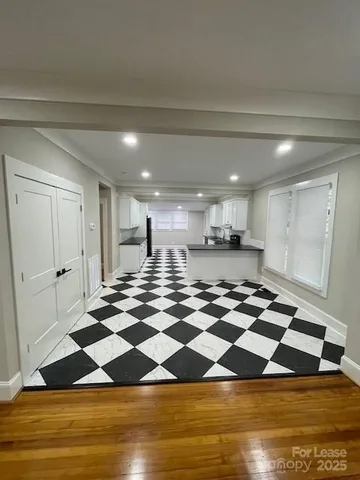 a room with wooden floor and pool table