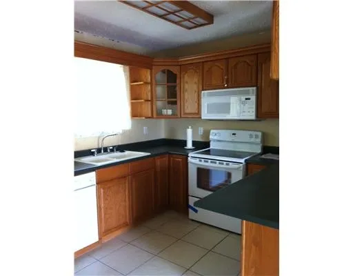a kitchen with stainless steel appliances granite countertop a stove and a microwave