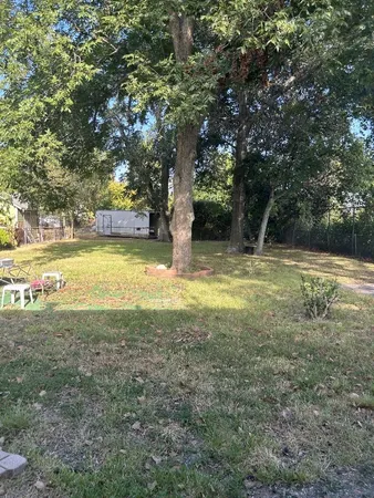 a view of yard with swimming pool and trees