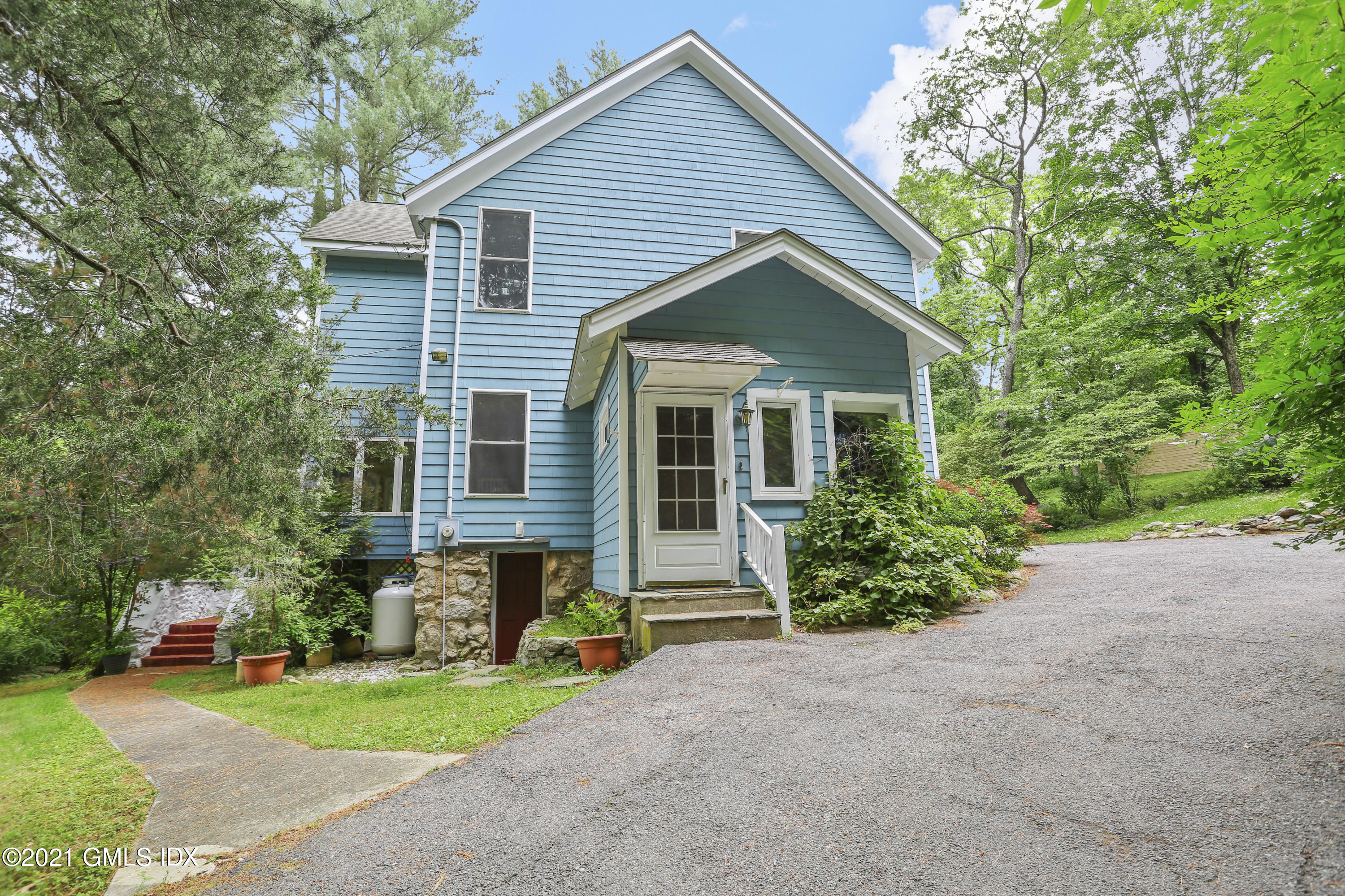 349 Riversville Road Greenwich, CT 06831 - Photo 1 of 28 a front view of house with yard and green space