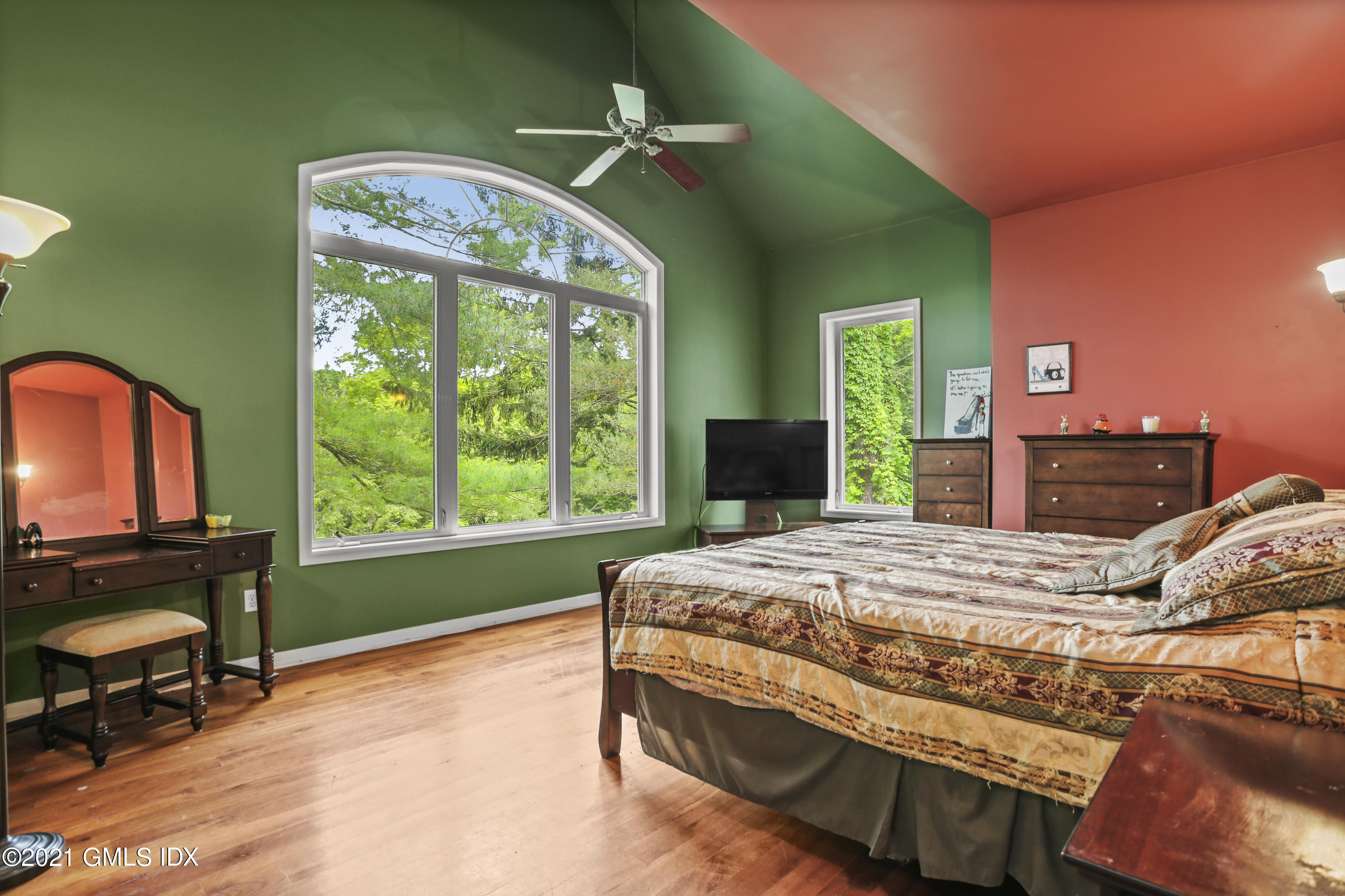 349 Riversville Road Greenwich, CT 06831 - Photo 20 of 28 a bedroom with a bed dresser and a large window