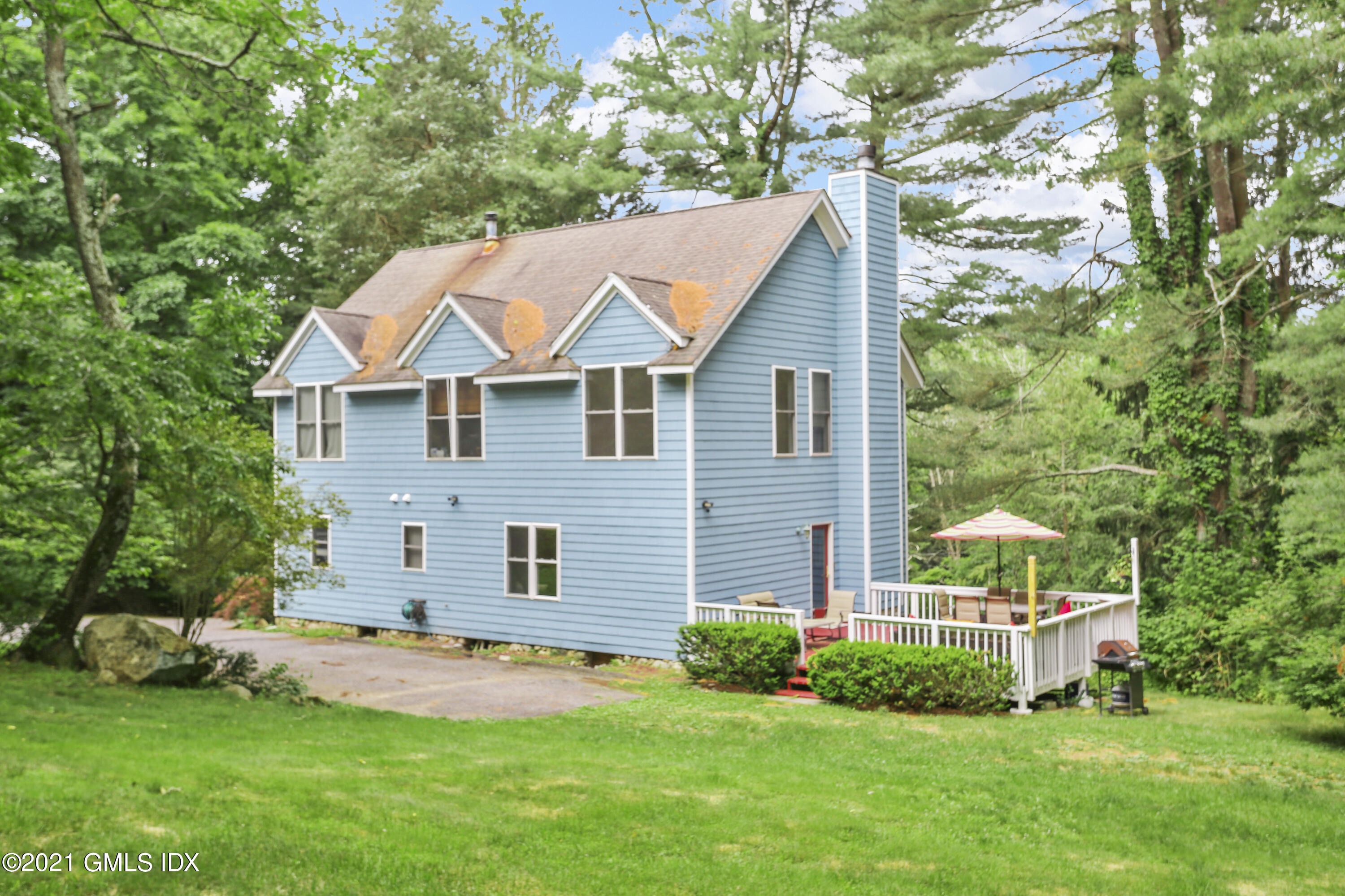 349 Riversville Road Greenwich, CT 06831 - Photo 2 of 28 a view of a house with a yard and plants
