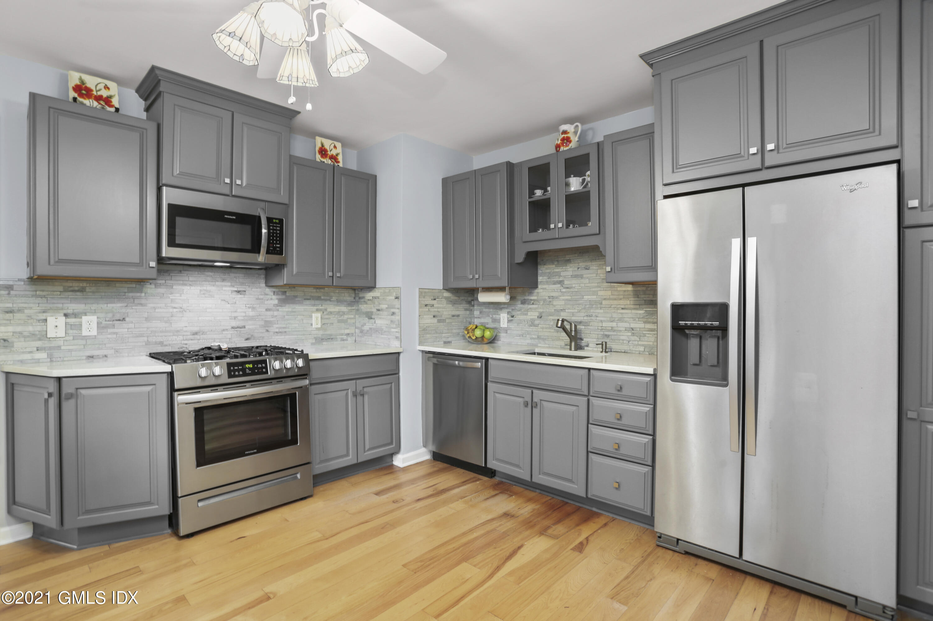 349 Riversville Road Greenwich, CT 06831 - Photo 5 of 28 a kitchen with granite countertop a refrigerator stove and microwave