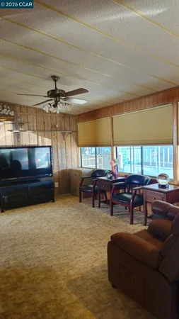 a view of kitchen with granite countertop cabinets and refrigerator