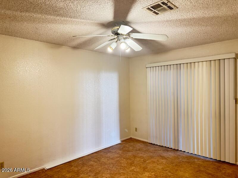 97 North Cooper Road, Unit 91 Chandler, AZ 85225 - Photo 16 of 28 a view of an empty room and chandelier fan