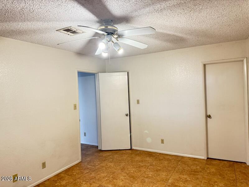 97 North Cooper Road, Unit 91 Chandler, AZ 85225 - Photo 18 of 28 an empty room with a ceiling fan and a window