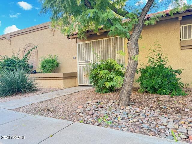 97 North Cooper Road, Unit 91 Chandler, AZ 85225 - Photo 2 of 28 a house that has a tree in front of it