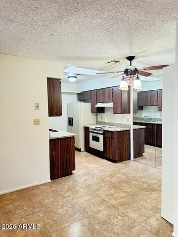 a large kitchen with stainless steel appliances a sink and cabinets