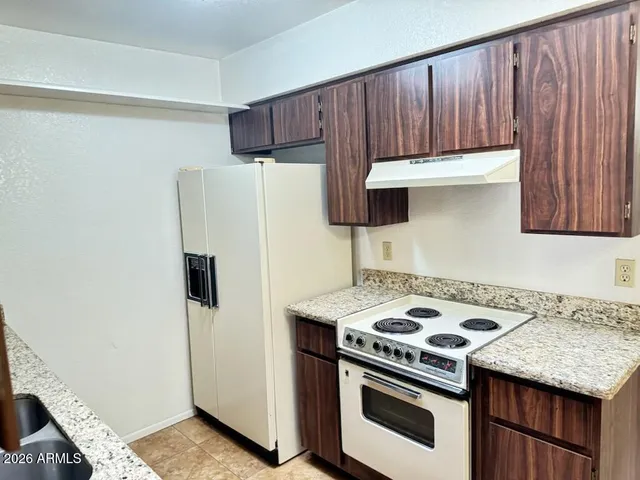 a kitchen with a stove and a refrigerator
