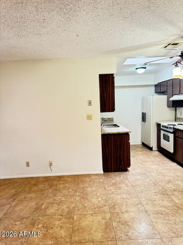 97 North Cooper Road, Unit 91 Chandler, AZ 85225 - Photo 7 of 28 a room with kitchen island and a flat screen tv