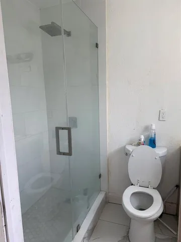 a white toilet sitting next to a bathroom sink