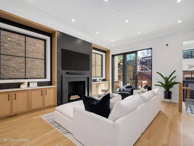 a living room with furniture and large windows