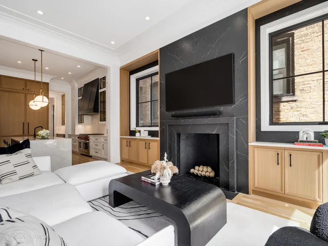 a bathroom with a tub a sink and a large mirror