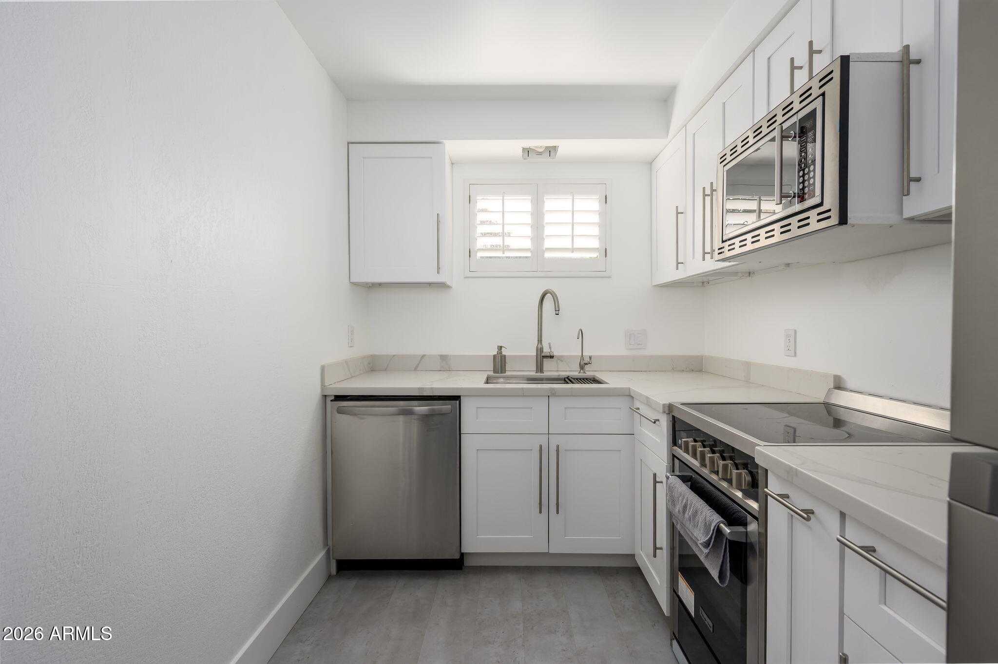 1004 East Osborn Road, Unit B Phoenix, AZ 85014 - Photo 2 of 22 a kitchen with a sink stove and cabinets