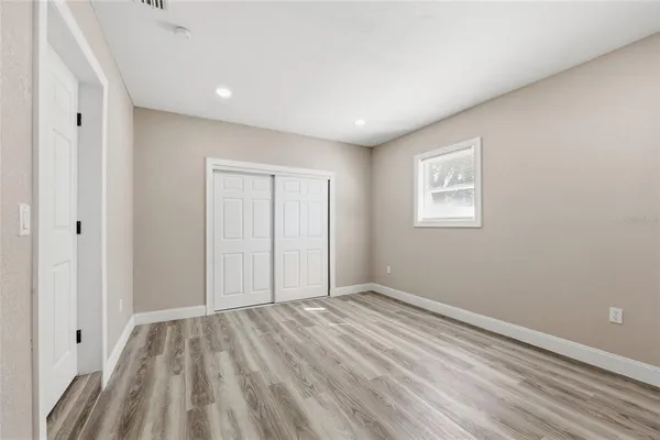 a view of room with window and hardwood floor
