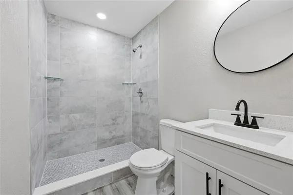 a bathroom with a sink toilet and a mirror