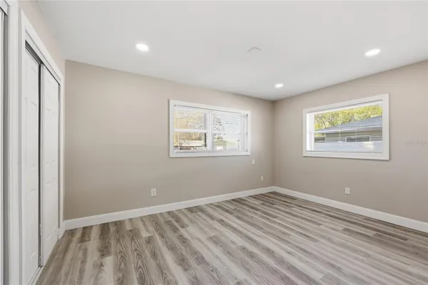 a view of room with window and wooden floor