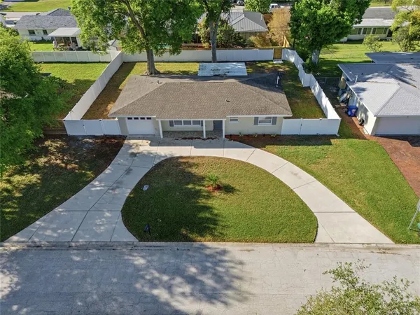 an aerial view of a house with swimming pool garden and patio