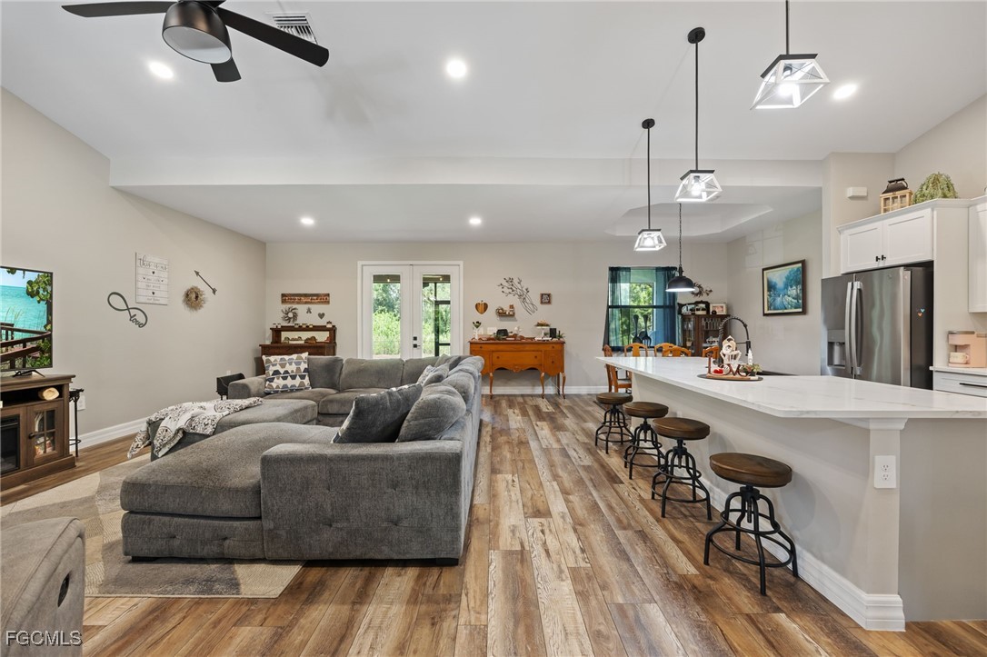 2391 Lippincott Road Alva, FL 33920 - Photo 12 of 50 a living room with furniture kitchen view and a wooden floor