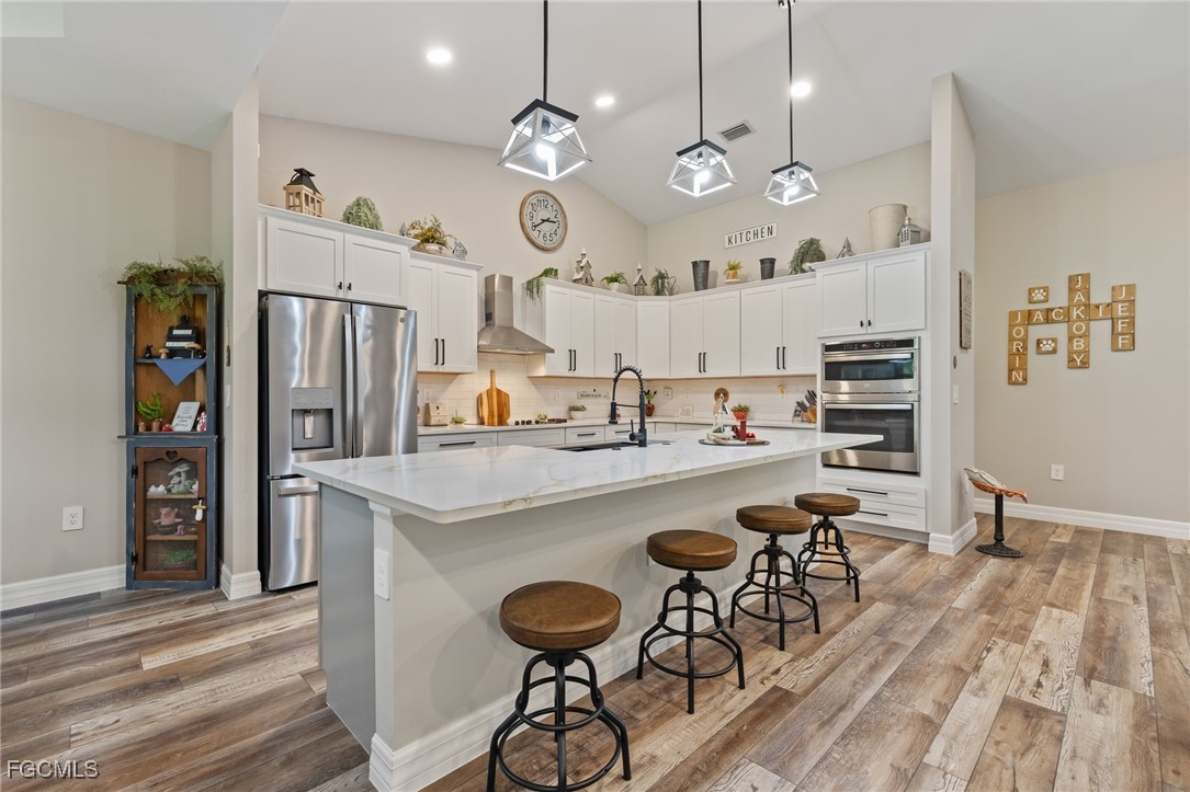 2391 Lippincott Road Alva, FL 33920 - Photo 18 of 50 a kitchen with a table chairs refrigerator and cabinets