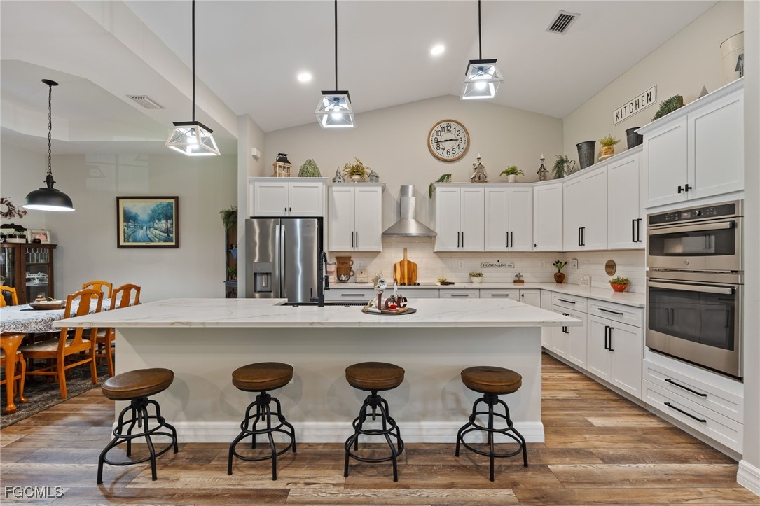 2391 Lippincott Road Alva, FL 33920 - Photo 19 of 50 a kitchen with cabinets and chairs