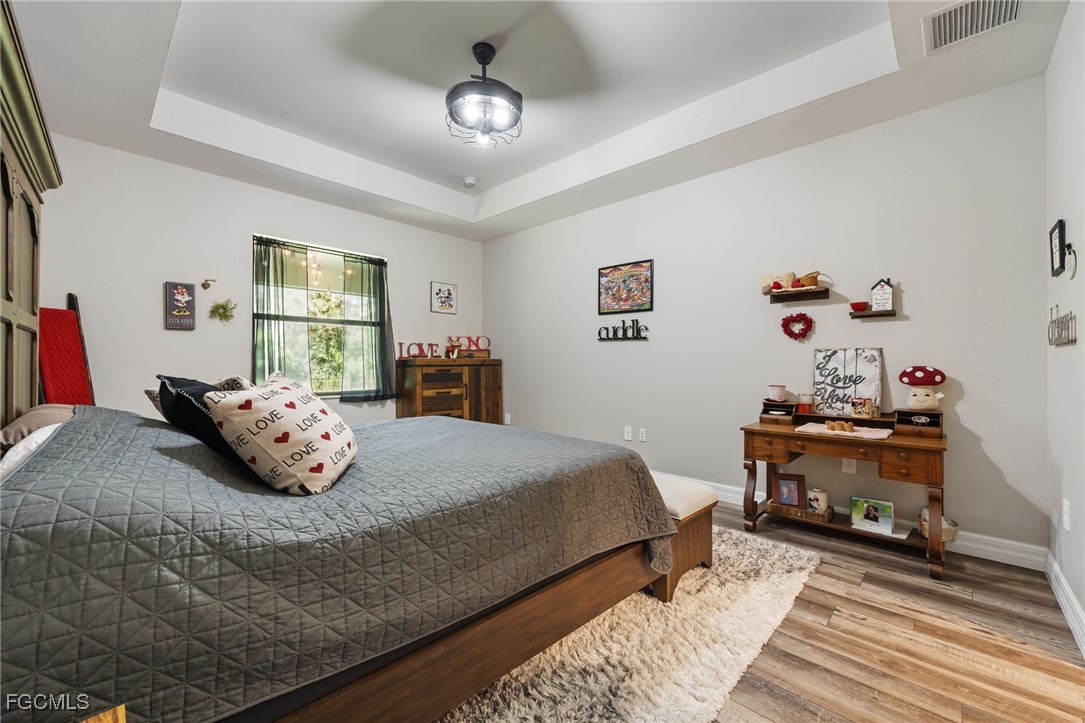 2391 Lippincott Road Alva, FL 33920 - Photo 24 of 50 a bedroom with a bed and a chandelier