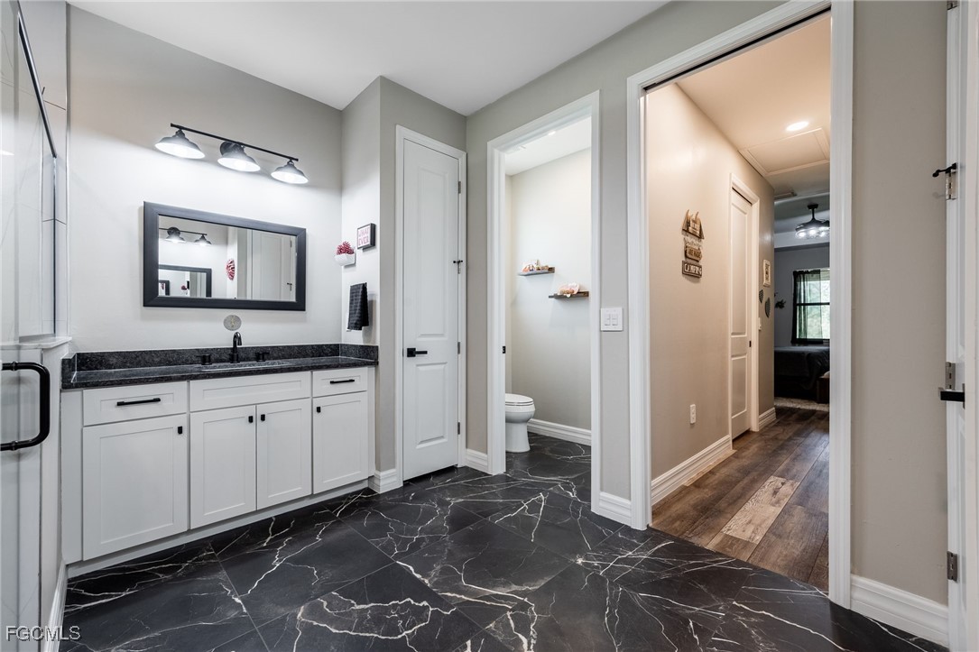 2391 Lippincott Road Alva, FL 33920 - Photo 28 of 50 a spacious bathroom with a granite countertop sink mirror and shower
