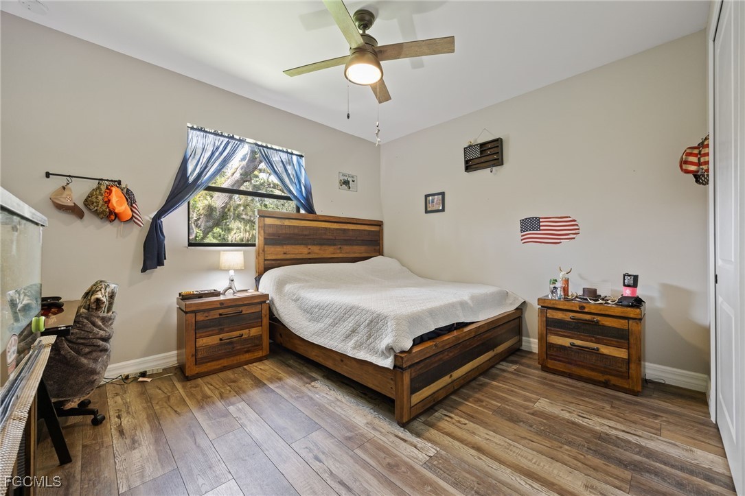 2391 Lippincott Road Alva, FL 33920 - Photo 33 of 50 a bedroom with a bed and a chandelier