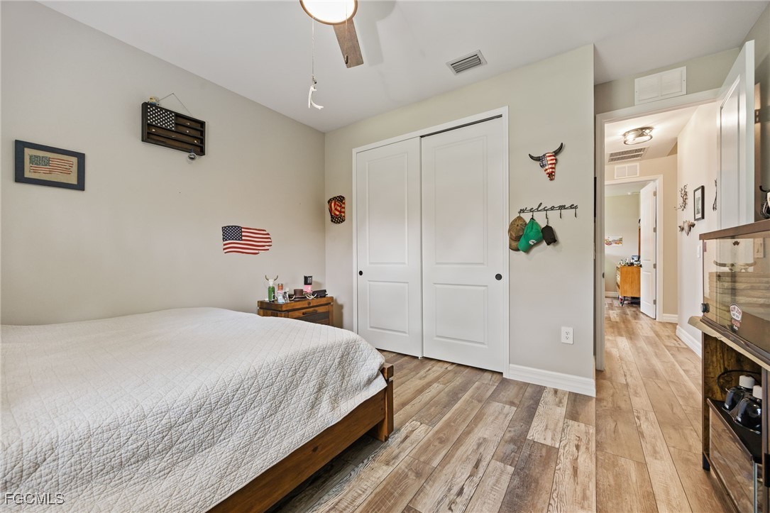 2391 Lippincott Road Alva, FL 33920 - Photo 34 of 50 a bedroom with a bed and a flat screen tv