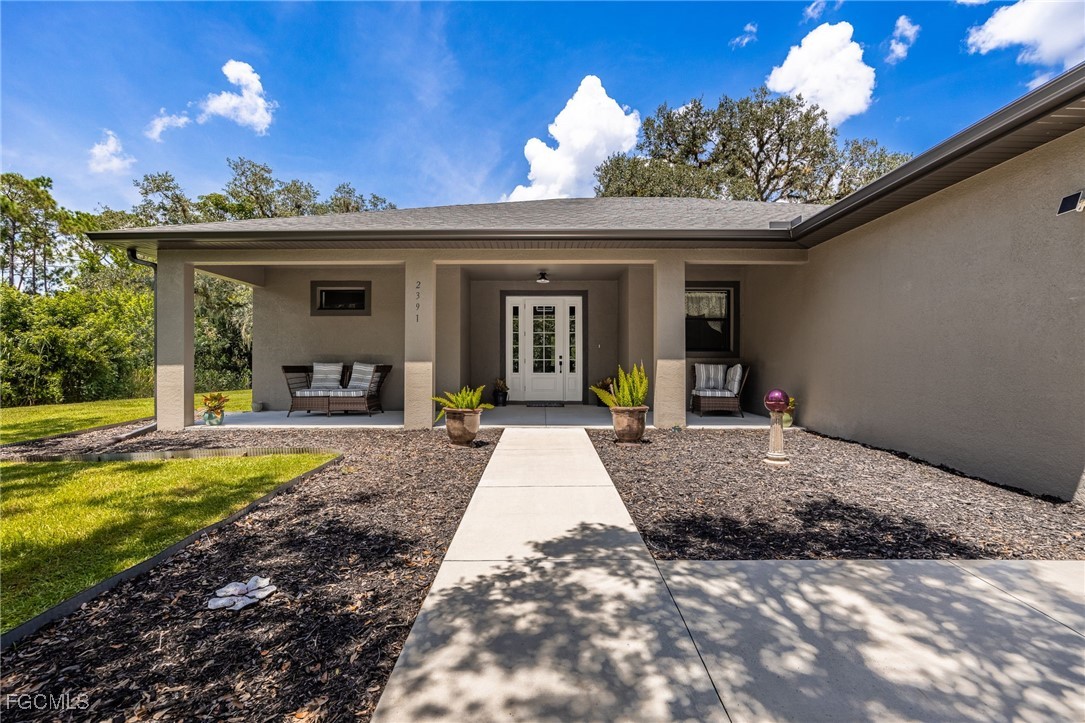 2391 Lippincott Road Alva, FL 33920 - Photo 8 of 50 a view of a house with entertaining space and a fire pit