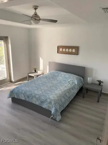 a bedroom with a bed and window
