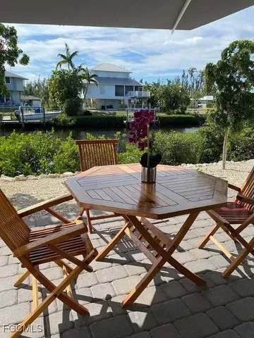 a view of a backyard with sitting area