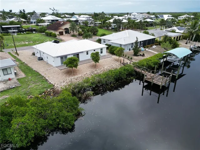 an aerial view of a house with outdoor space patio and lake view