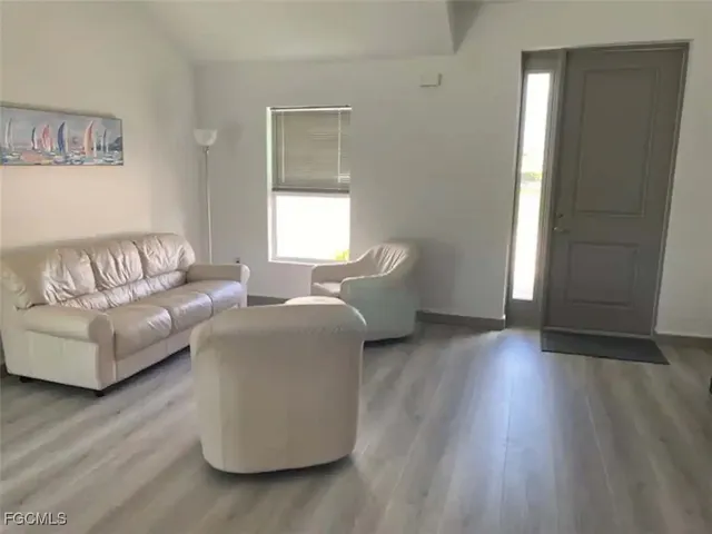 a living room with furniture and a window