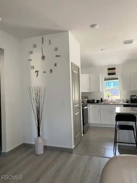 5351 Ann Arbor Drive Bokeelia, FL 33922 - Photo 7 of 21 a kitchen with white cabinets and stainless steel appliances