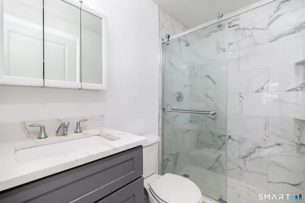 a bathroom with a sink toilet and shower