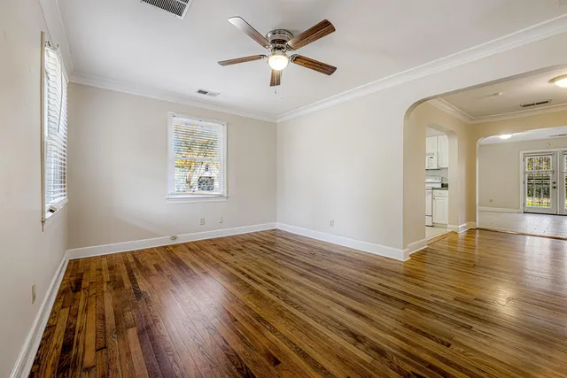 wooden floor in an empty room with a window
