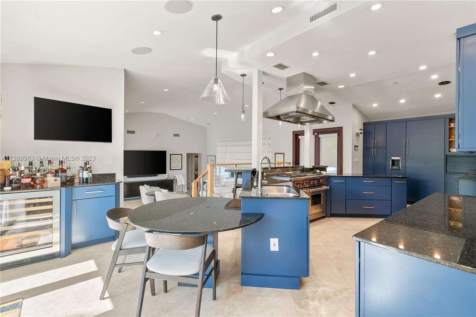 12521 Ramiro Street Coral Gables, FL 33156 - Photo 12 of 53 a large kitchen with a table and chairs