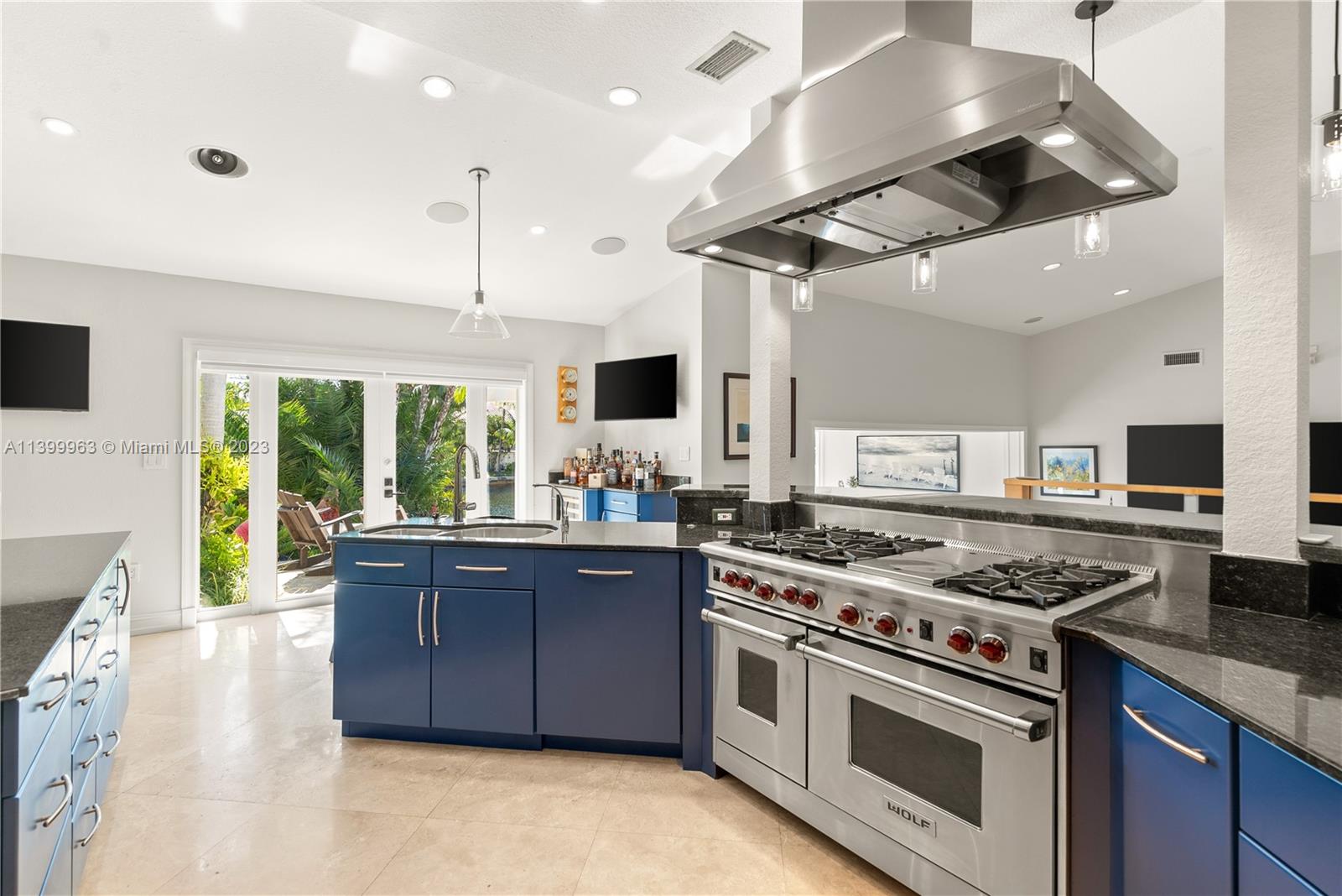 12521 Ramiro Street Coral Gables, FL 33156 - Photo 15 of 53 a kitchen with stainless steel appliances granite countertop a stove and a view of living room