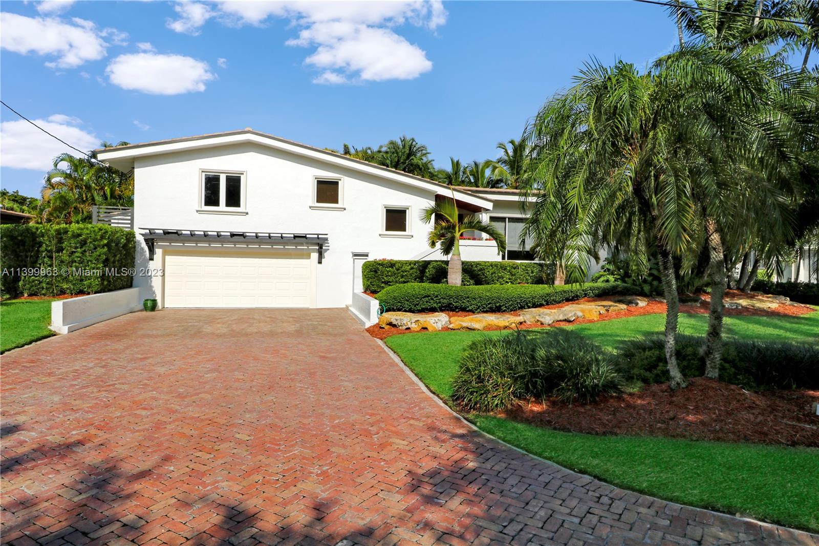 12521 Ramiro Street Coral Gables, FL 33156 - Photo 2 of 53 a front view of a house with a yard and garage