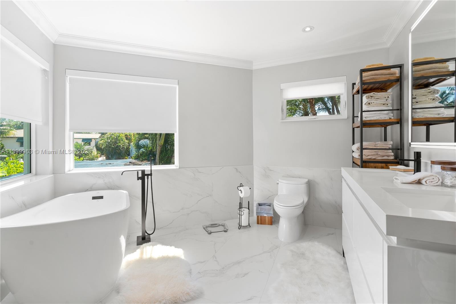 12521 Ramiro Street Coral Gables, FL 33156 - Photo 23 of 53 a bathroom with a sink a toilet and a large mirror