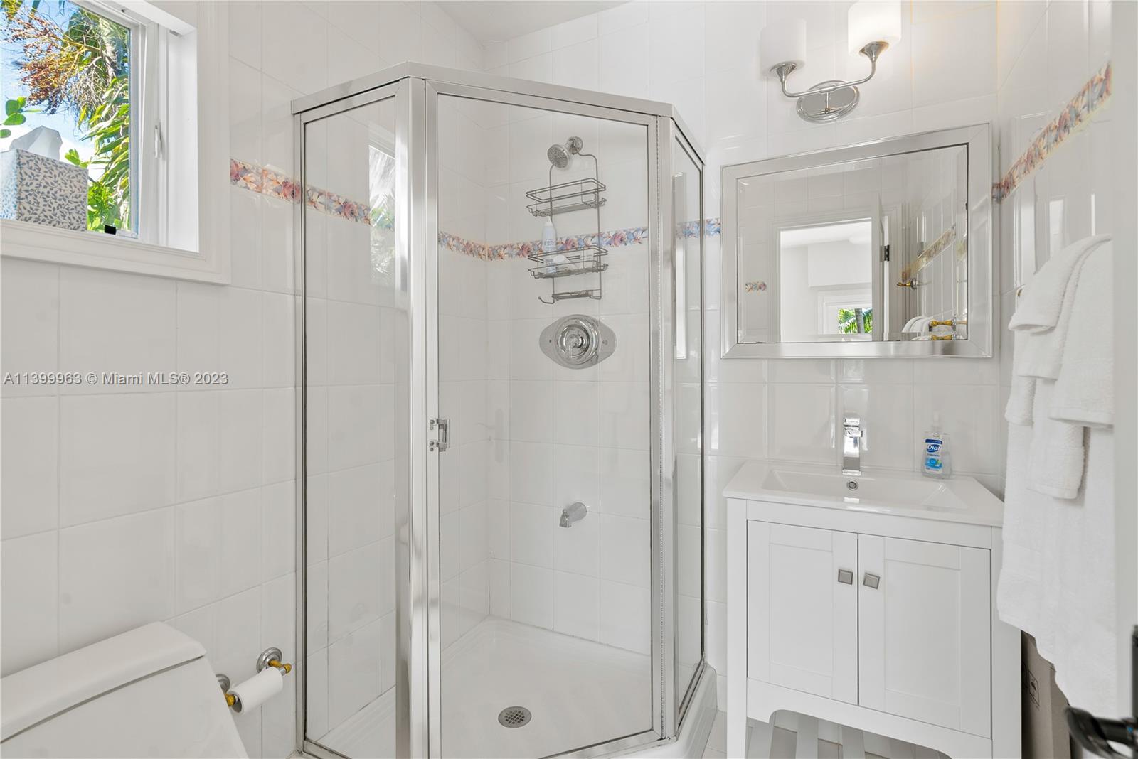 12521 Ramiro Street Coral Gables, FL 33156 - Photo 28 of 53 a bathroom with a shower a sink a mirror a vanity and a shower