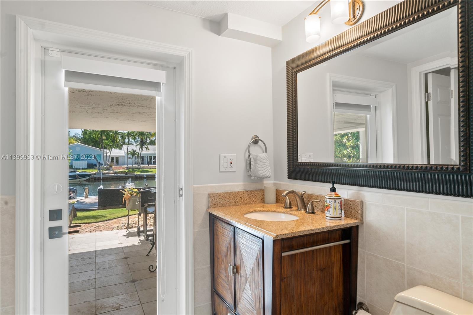 12521 Ramiro Street Coral Gables, FL 33156 - Photo 32 of 53 a bathroom with a sink and a mirror