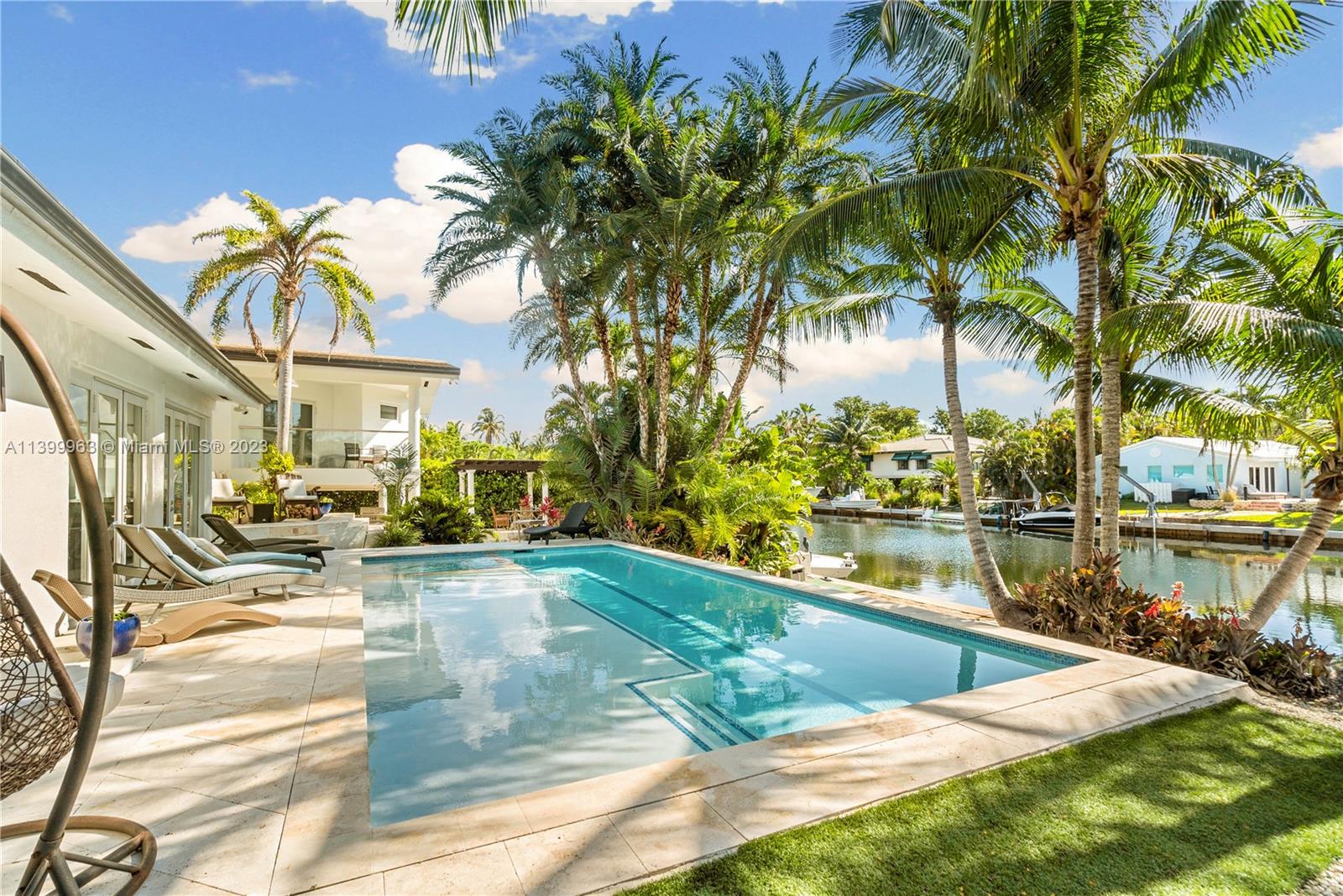 12521 Ramiro Street Coral Gables, FL 33156 - Photo 37 of 53 a view of a swimming pool with an outdoor seating