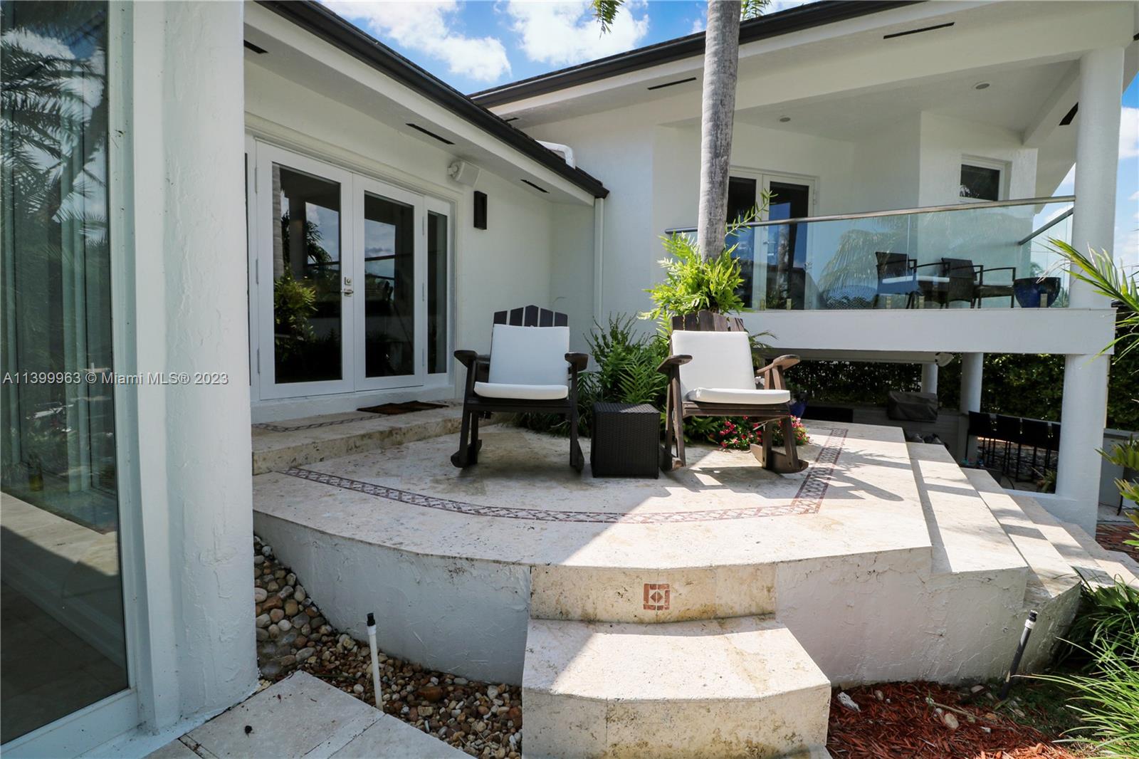 12521 Ramiro Street Coral Gables, FL 33156 - Photo 39 of 53 a living room with furniture and a fireplace