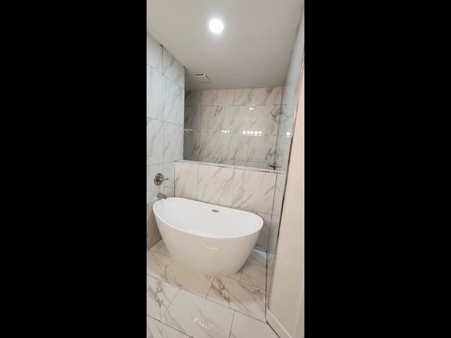 4566 Independent Road Bartlett, TN 38002 - Photo 11 of 23 Full bath with marble finish flooring, a soaking tub, and tile walls