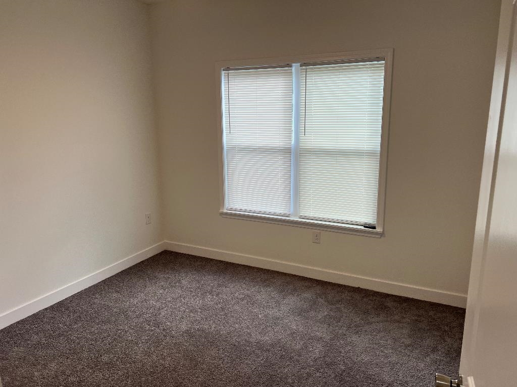 4566 Independent Road Bartlett, TN 38002 - Photo 18 of 23 Empty room with dark carpet and healthy amount of natural light