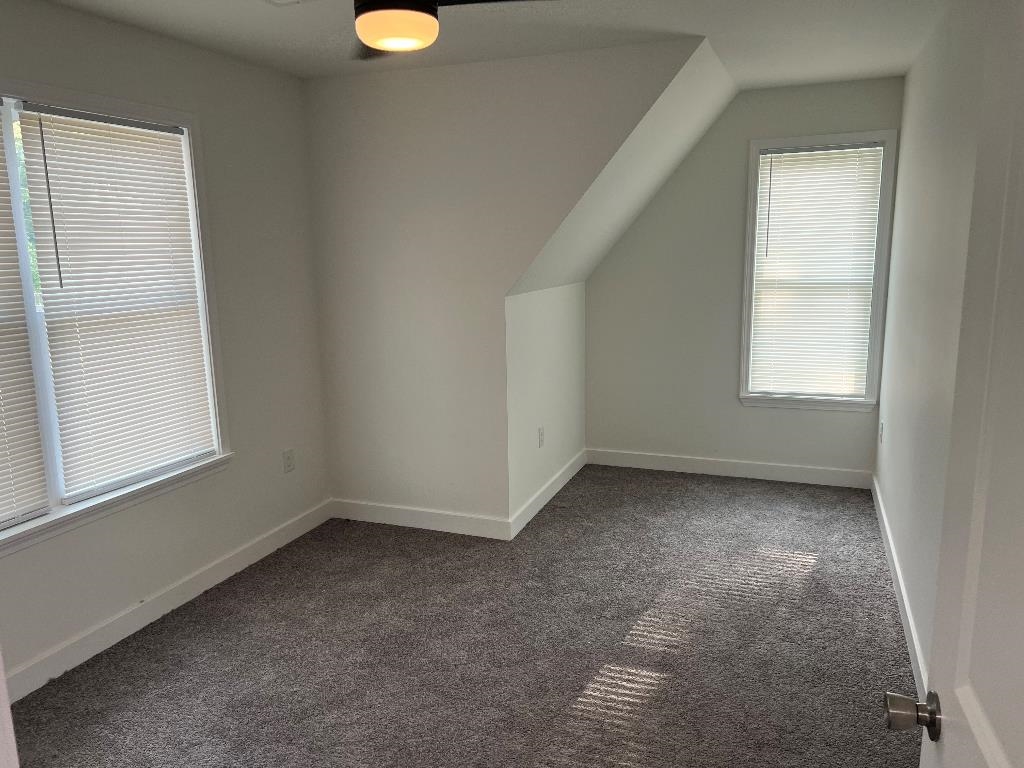 4566 Independent Road Bartlett, TN 38002 - Photo 20 of 23 Additional living space with dark colored carpet and lofted ceiling